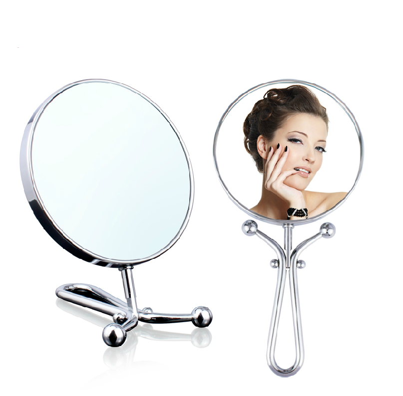 Mia® 10x/1x Folding Mirror - Handheld + Table + Wall - Polished Chrome - shown folded and unfolded with lady looking into mirror - #MiaKaminski #Mia #beauty #mirrors #lovethis #life #woman #vanitymirror